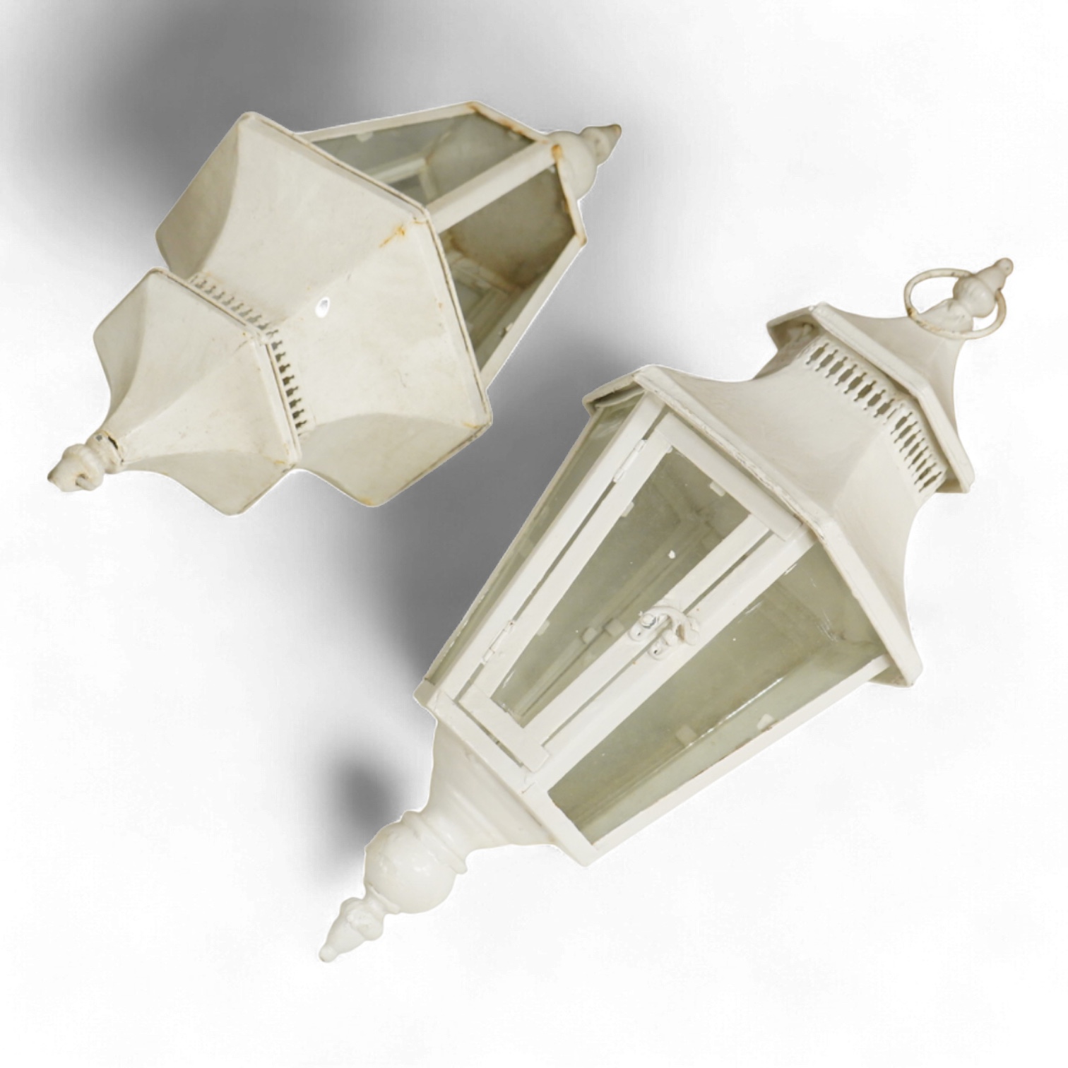 A pair of hexagonal painted hanging lanterns with glass panels, 54cm high